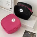 Detail macro view of square mesh travel toiletry organizer bags in black and pink colors - Bright Red