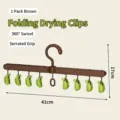 Brown folding drying rack with 8 green clips for travel and home laundry use - 1 Piece / Brown