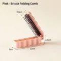 Compact pink folding boar bristle hairbrush for travel with 12cm unfolded length. - Pink