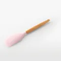 Pink silicone spatula with ergonomic wooden handle for non-stick cookware cooking. - Spatula