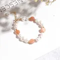 Elegant irregular freshwater pearl bracelet with peach sunstone beads and gold clasp - Three Pearls Sunstone Bracelet
