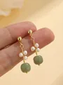 Close-up detail of elegant gold earrings featuring white pearls and round green jade beads - Light Green He Tian Jade Stud Earrings / Stud Pin Style / Light Green