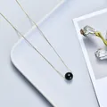 Elegant minimalist gold chain necklace featuring a single polished black bead pendant. - Obsidian / Gold