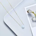 Elegant minimalist gold chain necklace featuring a single light blue round crystal bead. - Aquamarine / Gold