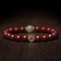 Elegant red cinnabar bead bracelet featuring a green jade accent and metallic zodiac charm - Zodiac Dog/Pig - Amitabha / 10mm