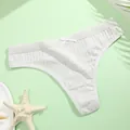 Close-up detail of a white ribbed cotton thong featuring a small decorative bow - M / White