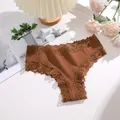 Close-up of brown cotton bikini panties with delicate lace trim detail - Brick Yellow
