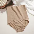 Detailed view of high-waist seamless tummy control shapewear in nude beige tone - M / Bottoms / Khaki