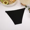 Detail view of black seamless ice silk bikini panties on a white textured background - S / Bottoms / Black