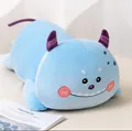Close-up of a cute blue monster plush bolster pillow with purple horns and tail - Blue / 50cm