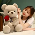 Soft plush teddy bear holding a large red rose, ideal Valentine's Day romantic gift - 23cm / Brown