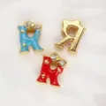 8mm alphabet charm in golden alloy featuring colorful enamel bows and sparkling rhinestones - Letter R