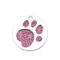 Detailed view of a circular metal pet ID tag featuring a pink glitter paw print design - Dog Paw Print (HC485) / Pink