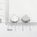 Detailed view of two garlic-shaped alloy beads measured on a centimeter ruler for scale - Garlic Style (SL546)