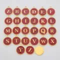 Detail showing the full set of 26 red enamel and gold stainless steel alphabet charms. - Letter-M / Red