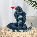 Realistic blue and black patterned coiled cobra plush toy prank prop displayed on woven mat - Approx. 110cm / Blue Cobra