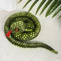 Realistic green plush snake toy with yellow spots and red eyes in a coiled pose. - Cyan Pattern Coiled Snake