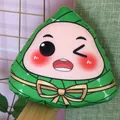 Cute winking Zongzi plush toy pillow with green leaf pattern and yellow bow detail - Happy Face Style