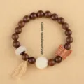 Elegant sandalwood beaded bracelet with white jade lotus charm and butterfly detail - Butterfly Golden Silk Sandalwood Style