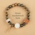 Handcrafted green sandalwood bead bracelet with white jade flower and wooden butterfly charm - Butterfly Green Sandalwood Style