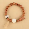 Natural sandalwood bead bracelet with butterfly charm and white stone tassel detail - Butterfly Peach Wood Style