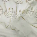 Close-up of white and gold floral embroidery on fine mesh lace fabric - 15 Yards/Pack / Platinum