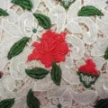 Macro view of premium water-soluble lace fabric with 3D red rose floral embroidery - White Red Green