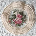 Detailed view of vintage round lace coaster with pink floral embroidery patterns. - Diameter 11.5cm / Beige