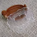 Close-up view of intricate floral embroidery and scalloped edge on white organza lace placemat. - Diameter 33cm / 42# Scroll Floral Pattern