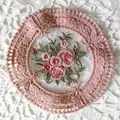 Detailed view of a vintage circular lace coaster with exquisite pink floral embroidery - Diameter 11.5cm / Dusty Pink