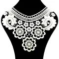 Macro view of white water-soluble lace floral collar with intricate hollowed embroidery. - White