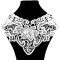 Detailed macro view of white water-soluble lace collar with hollow floral embroidery - White