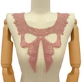 Detail view of pink milk silk lace collar with intricate hollow bow embroidery on mannequin. - Bow Knot Collar / Rose Pink