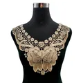 Detail view of a golden water-soluble lace collar featuring intricate butterfly embroidery - Coffee