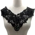 Detail view of black water-soluble lace collar with 3D floral embroidery on mannequin. - Black