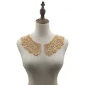 Detailed view of camel floral milk silk embroidery lace collar on mannequin torso - Gold Coffee