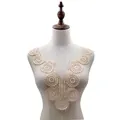 Detailed view of beige water-soluble embroidered lace collar applique on a mannequin torso - Beige