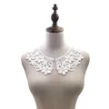 Detail view of white water-soluble milk silk embroidered lace collar on a dress form - White