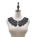 Detail view of black water-soluble lace collar embroidery on a mannequin bust - Black