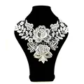 Detailed view of white water-soluble lace collar featuring delicate rose embroidery patterns - White