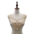 Detail view of intricate water-soluble butterfly lace collar on a mannequin torso - Beige
