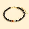 Elegant black onyx beaded bracelet featuring a red rhodochrosite bead and golden charm - Southern Red Aquamarine Black Agate Bracelet