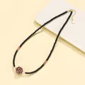 Handmade black agate necklace featuring amethyst beads and a unique patterned lacquer bead. - Lacquer Bead Black Agate Necklace (Purple)