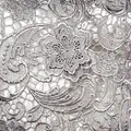 Detailed macro view of intricate silver paisley water-soluble embroidered lace fabric texture - Gray