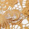 Macro view of gold water-soluble lace fabric with intricate paisley embroidery patterns - Gold Coffee