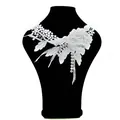 Detailed macro view of white water-soluble lace floral collar embroidery on a black bust - White