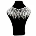 Detailed close-up of white leaf pattern embroidery on water-soluble lace applique collar - White