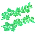 Detailed macro view of two green embroidered 3D lace floral patches for fashion accessories - Green
