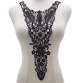 Close-up of elegant black lace embroidery neckline applique patch on mannequin display. - Black