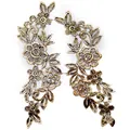 Close-up of gold water-soluble floral lace embroidery applique for DIY projects. - Foil Stamping